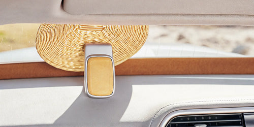A compact visor clip air freshener on a car's sun visor.
