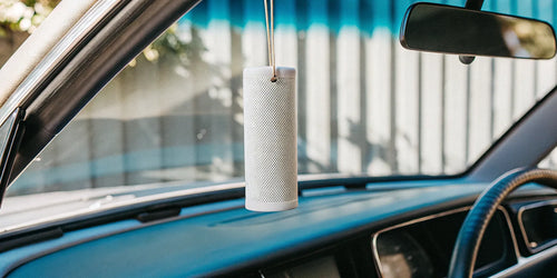 Review of the best Drift air freshener with its wood clip design hanging in a car.