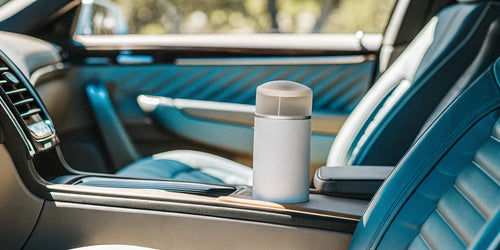 Cologne car air freshener on the center console of a luxury vehicle.