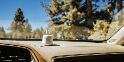 A non-toxic car air freshener on a dashboard, featured in a product review.