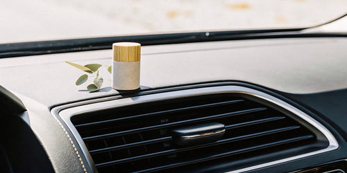 Natural wood car scent diffuser on a modern car vent