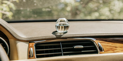The best air freshener for a luxury car, with a minimalist design on a dashboard.